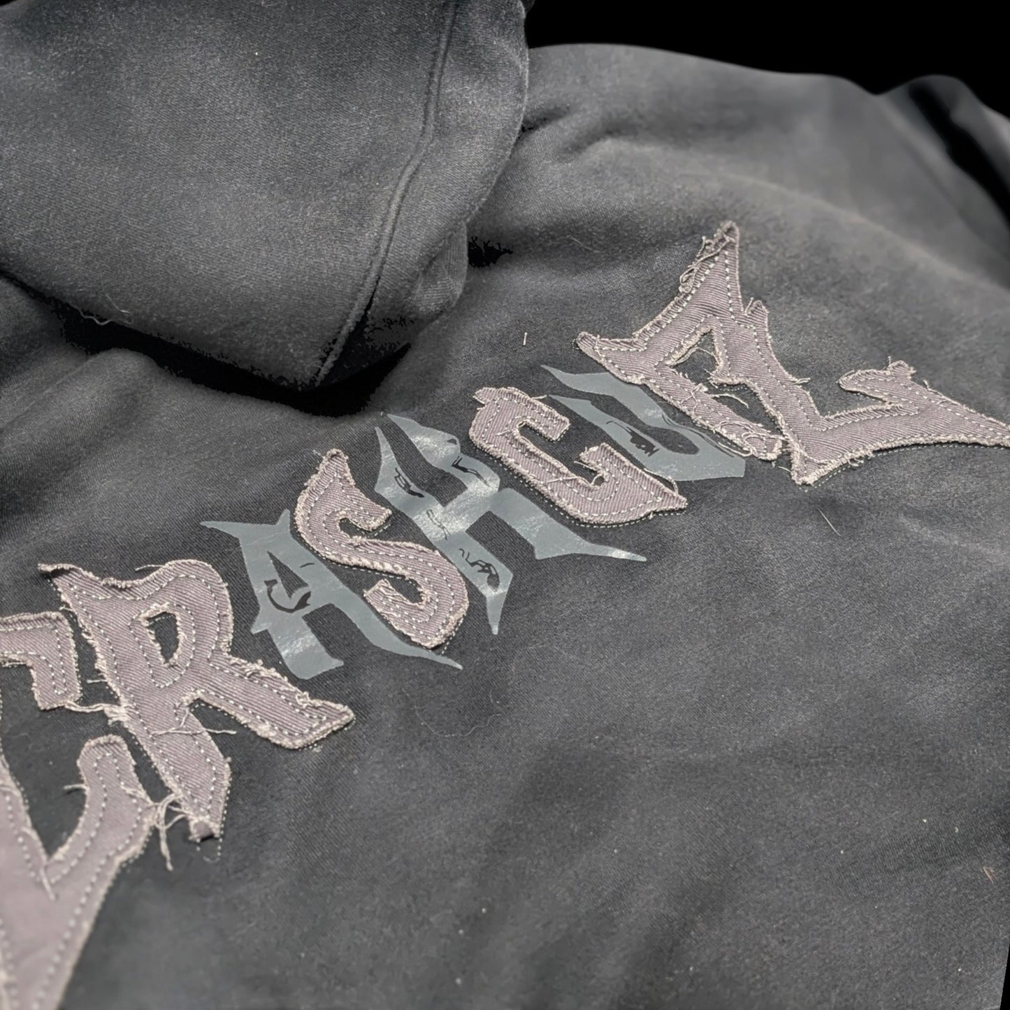 CrashCutz black heavyweight 100% cotton hoodie with distressed embroidery and printed graphic mix. Features oversized fit and double-layer hood.